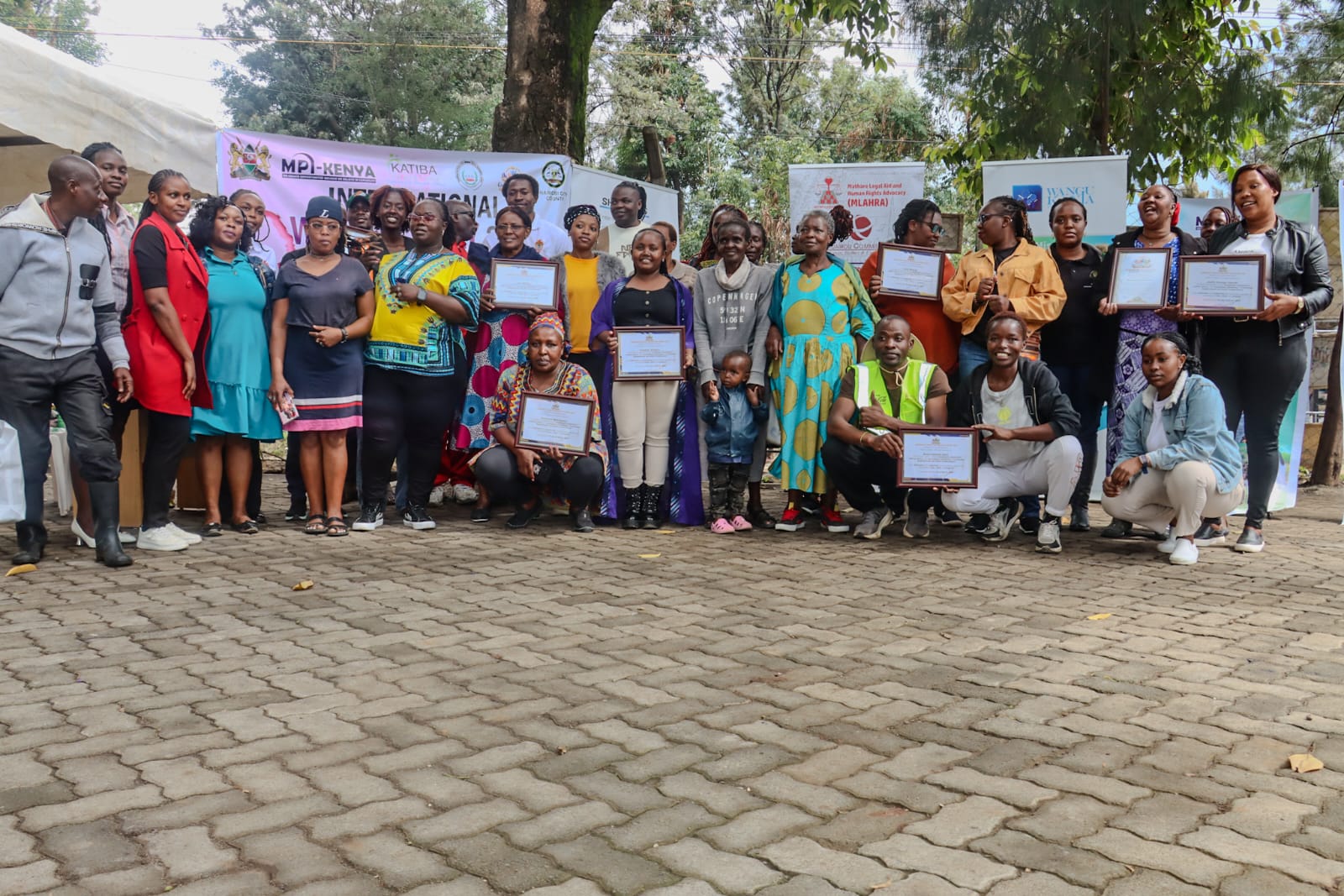 Women receiving certificates at the IWD 2026 community event, Mathare, Nairobi